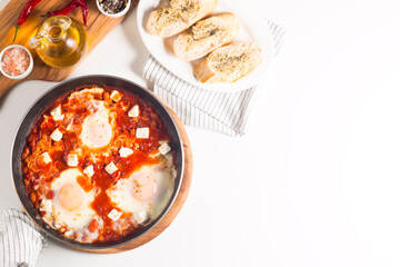 Shakshuka made of poached eggs in tomato pepper sauce