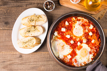 Shakshuka made of poached eggs in tomato pepper sauce