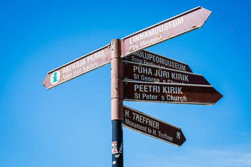 Fototapeta premium Tartu, Estonia - May 25, 2024: Sign pointing to different sights and tourist attractions in Tartu, Estonia. Travel information signpost for Tartu visitors. 