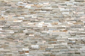 External wall covering made of  brick stones of different colors. Full frame. Background and...