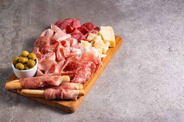 Charcuterie board. Antipasti appetizers of meat platter with salami, prosciutto crudo or jamon and olives.