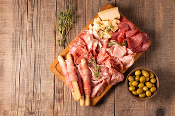Charcuterie board. Antipasti appetizers of meat platter with salami, prosciutto crudo or jamon and olives.