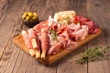 Charcuterie board. Antipasti appetizers of meat platter with salami, prosciutto crudo or jamon and olives.