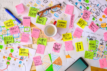 Calendar with business appointments and deadlines,pens,coffee cup and spectacles, monthly schedule. Business concept beat the clock. Free copy space.