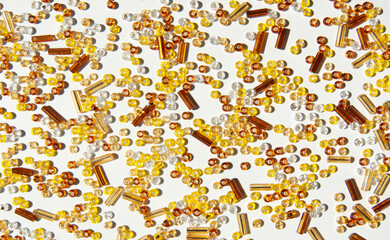 Fototapeta premium Yellow beads background. Yellow beads on white.