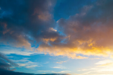 Blue sky background - picturesque vivid clouds lit by sunlight, sunset evening view