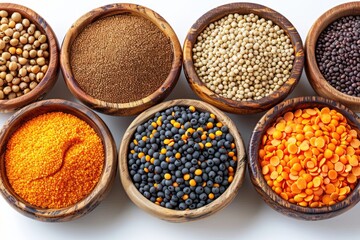 Wooden bowls filled with various types of lentils beans and seeds