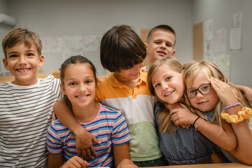 group of young students have fun and hug each other in the classroom