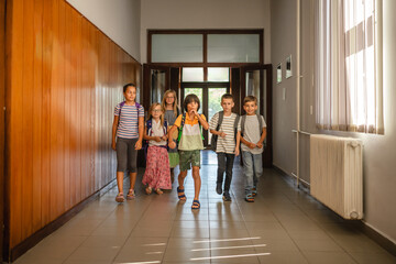 portrait of young happy students come, enter to school