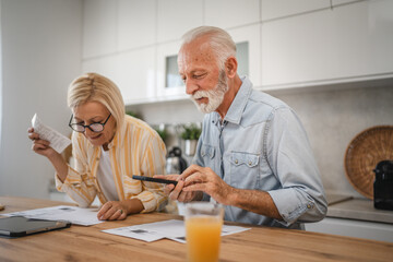 Senior man have contact less payment and mature woman read invoice