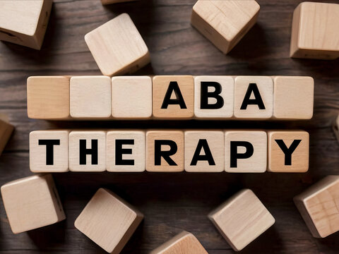 Abbreviation ABA therapy on wooden cubes