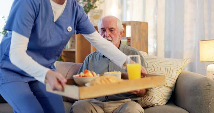 Caregiver, home and assistance with breakfast in elderly care for living room service, meal or food. Happy nurse serving lunch or dinner to senior man patient for support, trust or morning nutrition