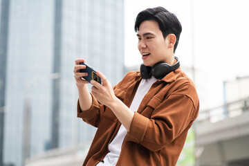 Handsome long legs of Asian men walking, listening to music and working on the street