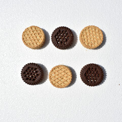 Two types of cookies: chocolate and plain on white background, top view