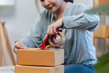 Young Woman Packing Boxes for Online Sales Business at Home Office, Small Business Owner Preparing...