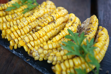 Roasted corn on a wooden table	
