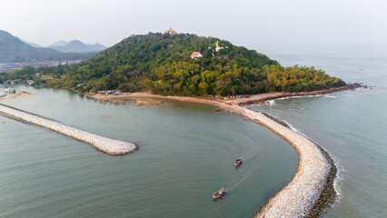 Aerial view of Ban Krut seaside with breakwater and view of Thang Sai temple, local fishing boats, Prachuap Khiri Khan Province, Thailand..