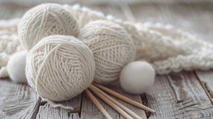 Close up of cotton yarn balls and knitting needles on a wooden table