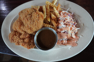 Malaysian food, chicken chop with fries and coleslaw