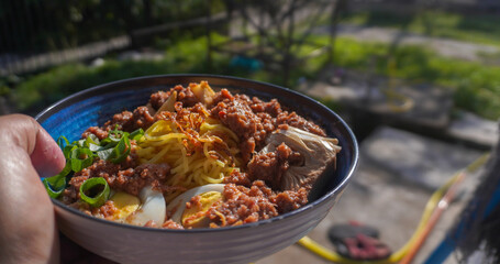 hand holding a plate of rojak in the outdoor