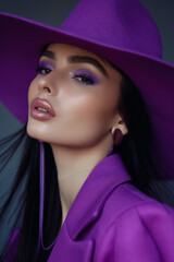A beautiful woman wearing ultra violet hat, in the style of a social media influencer, for a fashion magazine cover, vibrant colors