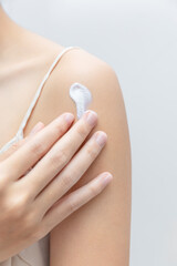 Body Care. Woman Applying Moisturizing Lotion Or Cream On Shoulders Caring For Skin At Home