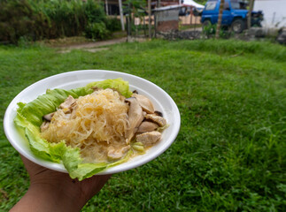 bowl of glass noddle's in the background of outdoor