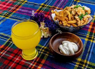 potato wedges with mayonnaise with orange juice on a picnic blanket