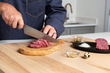 Chef hands slicing meat