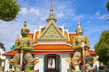 Two guardian giants in Wat Arun temple in Bangkok, Thailand