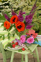 poppies and foxglove still life in a garden