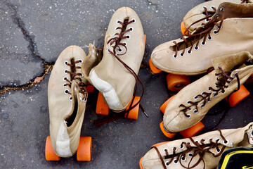 old fashioned rental roller skates with bright orange wheels