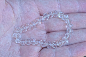 white plastic beads lie on the palm of the hand