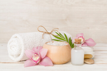 Composition with orchids, spa products on wooden table