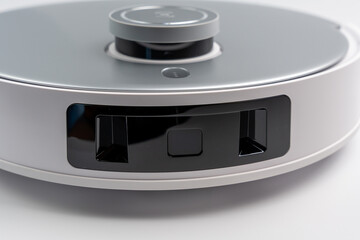 White and black robot with a black face. Robot vacuum cleaner on a white background.