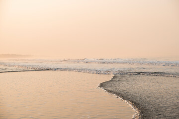 Ocean landscape with humid and misty air during heat wave, shot at sunset time. La Libertad beach, El Salvador, Central America.