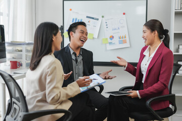 Group of professionals having a cheerful discussion during a business meeting in an office setting, brainstorm and teamwork concept.