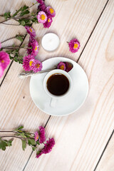 Autumn composition. Cup of coffee, notepad, fresh flowers on white background. Autumn, fall concept. Flat lay, top view, copy space