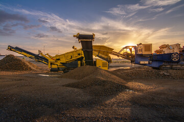Fototapeta premium Heavy and mobile machinery in a quarry to transform stone into construction material