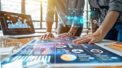 Hands of professionals collaborating over a digital interface displaying data analytics and futuristic holographic information.