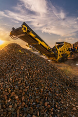 Heavy and mobile machinery in a quarry to transform stone into construction material
