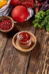 Tomato Sauce with Herbs and Spices on Wooden Background: Authentic Italian Flavors