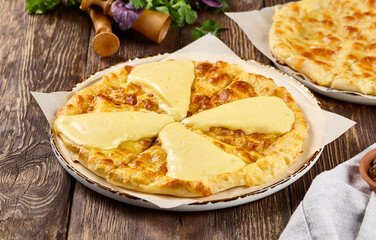 Authentic Imeretian Cheese Khachapuri on Rustic Wooden Table Background