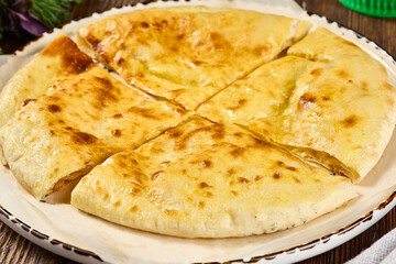 Traditional Ossetian Cheese Pie on Rustic Wooden Table