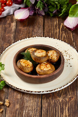 Baked Mushrooms with Cheese and Bacon on Ketsi - Gourmet Appetizer on Rustic Wooden Table