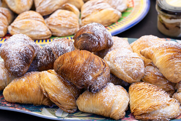 Sfogliatella pastries, traditional Italian dessert with flaky layers, powdered sugar on top. Freshly baked