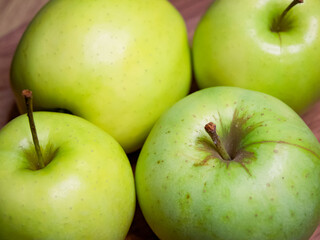 A close-up of green apples, emphasizing their organic quality, ideal for a health food campaign.