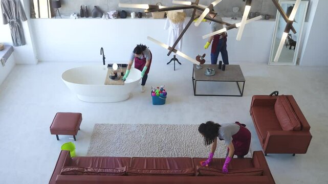 Highly skilled cleaning crew in modern homes achieving flawless results with meticulous care and precision. Top view, slow motion shot