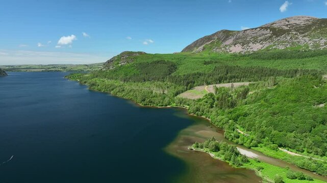 Blue lake with forested and hilly shoreline. Ennerdale, English Lake District, Cumbria, UK