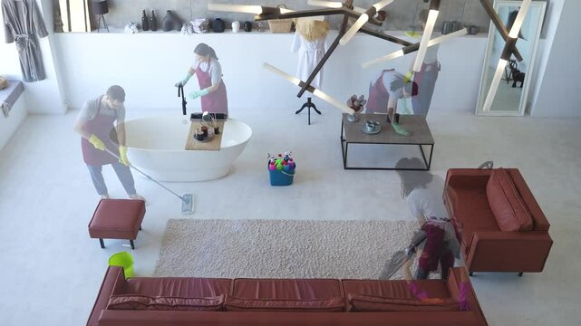 Diligent cleaners disinfecting a modern living room. Housekeeping and sanitation practices. Top view, timelapse